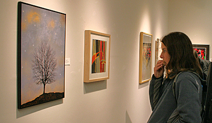 Visitor looks at artwork at one of the many art galleries in the Finger Lakes in upstate New York, USA.