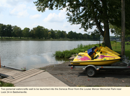 Two personal watercrafts wait to be launched into the Seneca River from the Louise Mercer Memorial Park near Lock 24 in Baldwinsville, New York, USA.
