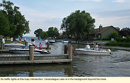 No traffice lights at this busy intersection at Canancaigua Lake State Marine Park. Canandaigua Lake is in the background beyond the trees.