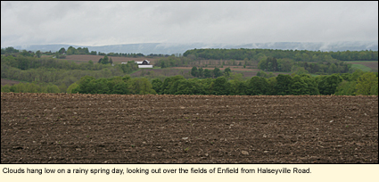 Clouds hang low on a rainy spring day, looking out over the field of Enfield, New YorK (USA) from Halseyville Road.