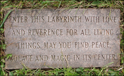 Entrance stone to a labyrinth in the Finger Lakes, New York USA. The stone says "Enter this labyrinth with love and reverence for all living things. May you find peace, solace and magic in its center."