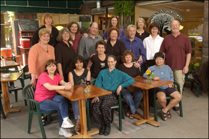 The Moosewood Collective sitting outside their restaurant in Ithaca, New York USA.