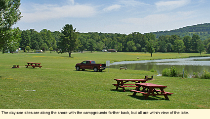 At KanaKadea Park near Hornell, New York, the day-use sites are along the shore of Almond Lake with the campgrounds farther back, but all are within view of the lake.