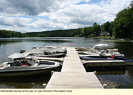 Motorboats docked at the pier of Lake Demmon Recreation Area in Howard, New York.