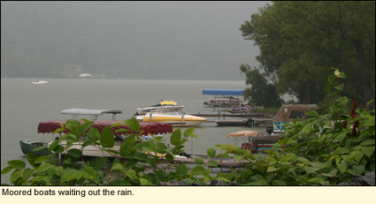 Moored boats in a rain on Otisco Lake in the Finger Lakes, New York USA.