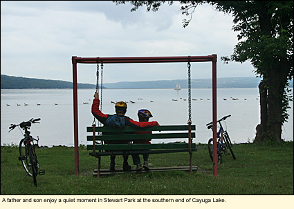 A father and son enjoy a quiet moment in Stewart park at the southern end of Cayuga Lake.