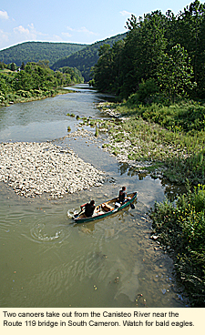 Two canoers take out from the Canisteo River near the Route 119 bridge in South Cameron. Watch for bald eagles along this river.