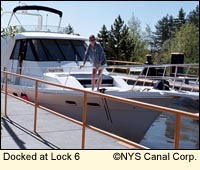 A large motorboat is docked at Lock 6 of the Erie Canal in New York State USA.