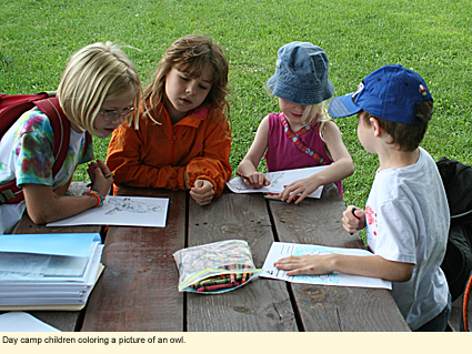 Day camp children coloring a picture of an owl at Baltimore Woods Nature Center in Marcellus, New York.