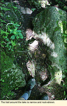 The trail around the lake is narrow and rock-strewn.