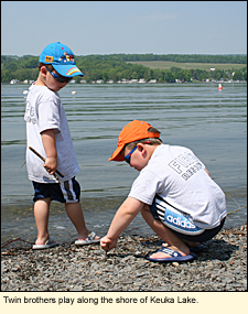 Twin brothers play along the shore of Keuka Lake.
