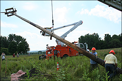 Photo 9-The pole is winched up to position it above the hole. Credit: Ronda Roaring