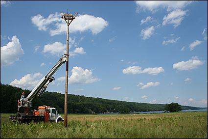 Photo 11-The pole is held in place so that dirt can be packed into the hole. Credit: Ronda Roaring