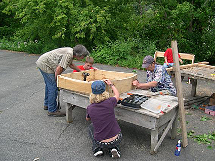 Photo 2-Dave Gell of Black Locust Initiative and his assistant Melanie work with a group from Trumansburg/Ulysses Youth Services on the osprey nest box. Credit: Bill Evans