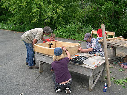 Photo 2-Dave Gell of Black Locust Initiative and his assistant Melanie work with a group from Trumansburg/Ulysses Youth Services on the osprey nest box. Credit: Bill Evans