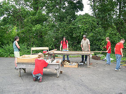 Photo 3-Dave Gell, executive director of Black Locust Initiative works with a group of teenagers from Trumansburg/Ulysses Youth Services on an osprey nest box made of black locust. Credit: Bill Evans