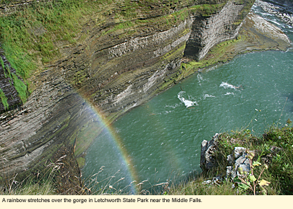 A rainbow stretches over the gorge in Letchworth State Park near the Middle Falls.