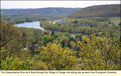 The Susquehanna River as it flows through the Village of Owego one spring day as seen from Evergreen Cemetery.